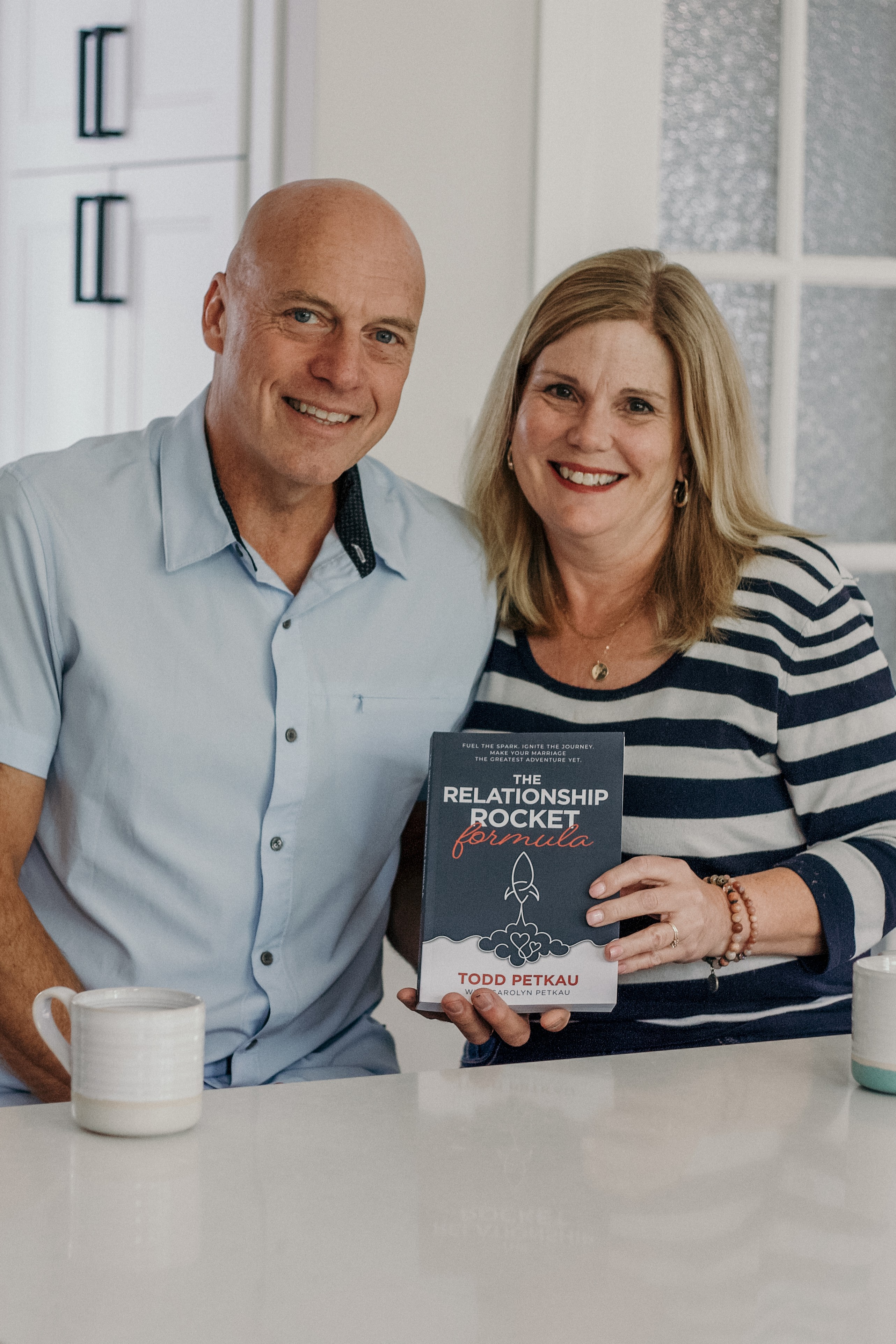 Todd and Carolyn holding The Relationship Rocket Formula book